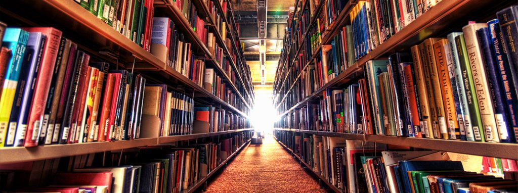 A library filled with lots of books and shelves.